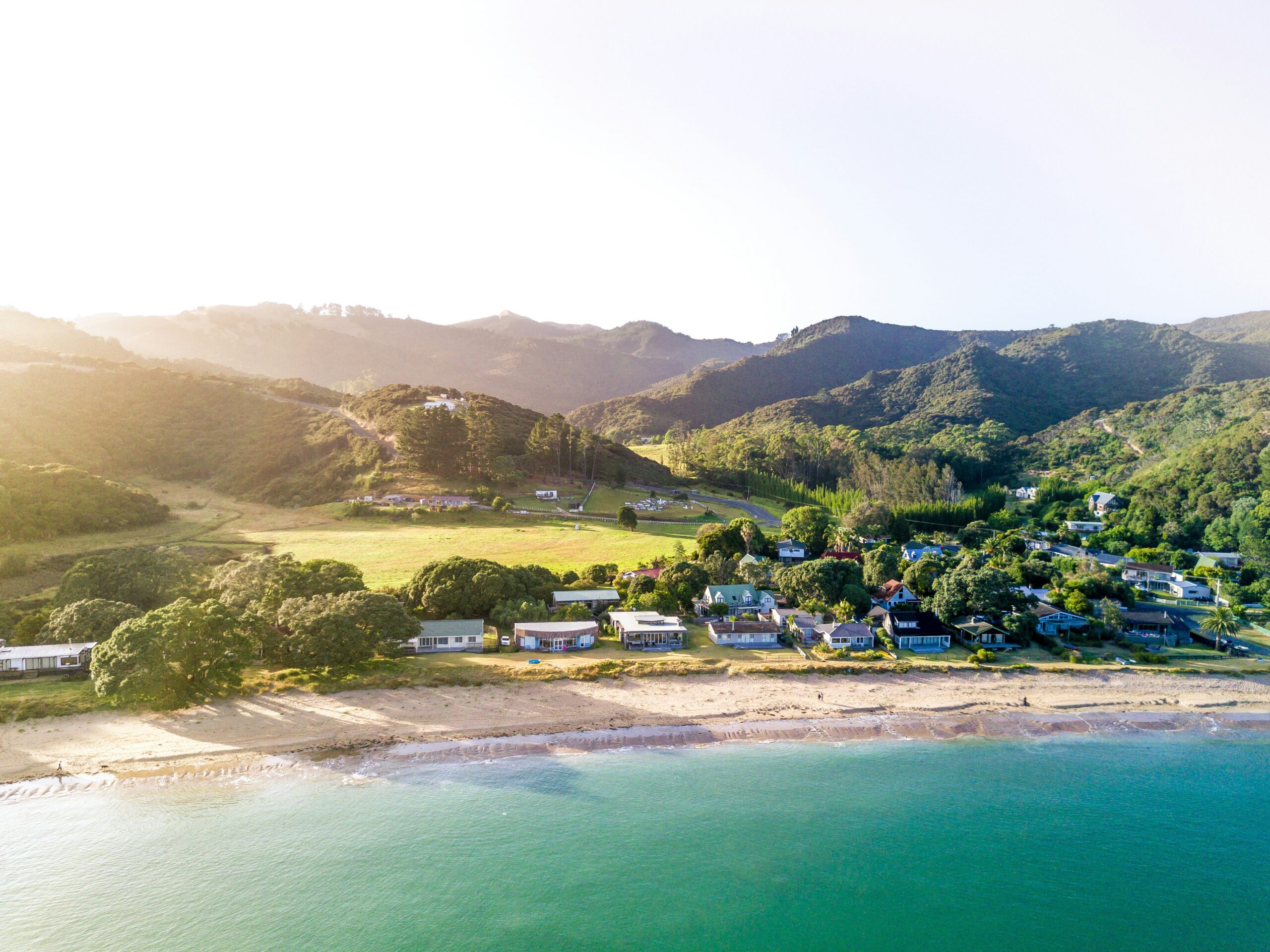 Landscape of a costal town surrounded by hills.