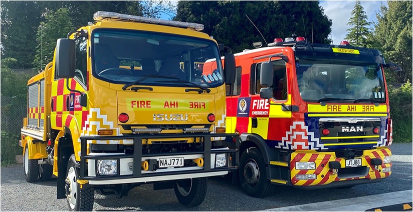 Two Fire and Emergency New Zealand trucks parked side by side.