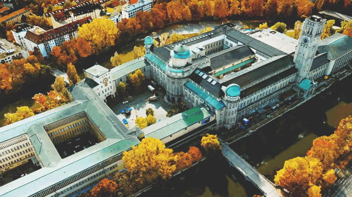 Aerial view of a large building complex beside a river.