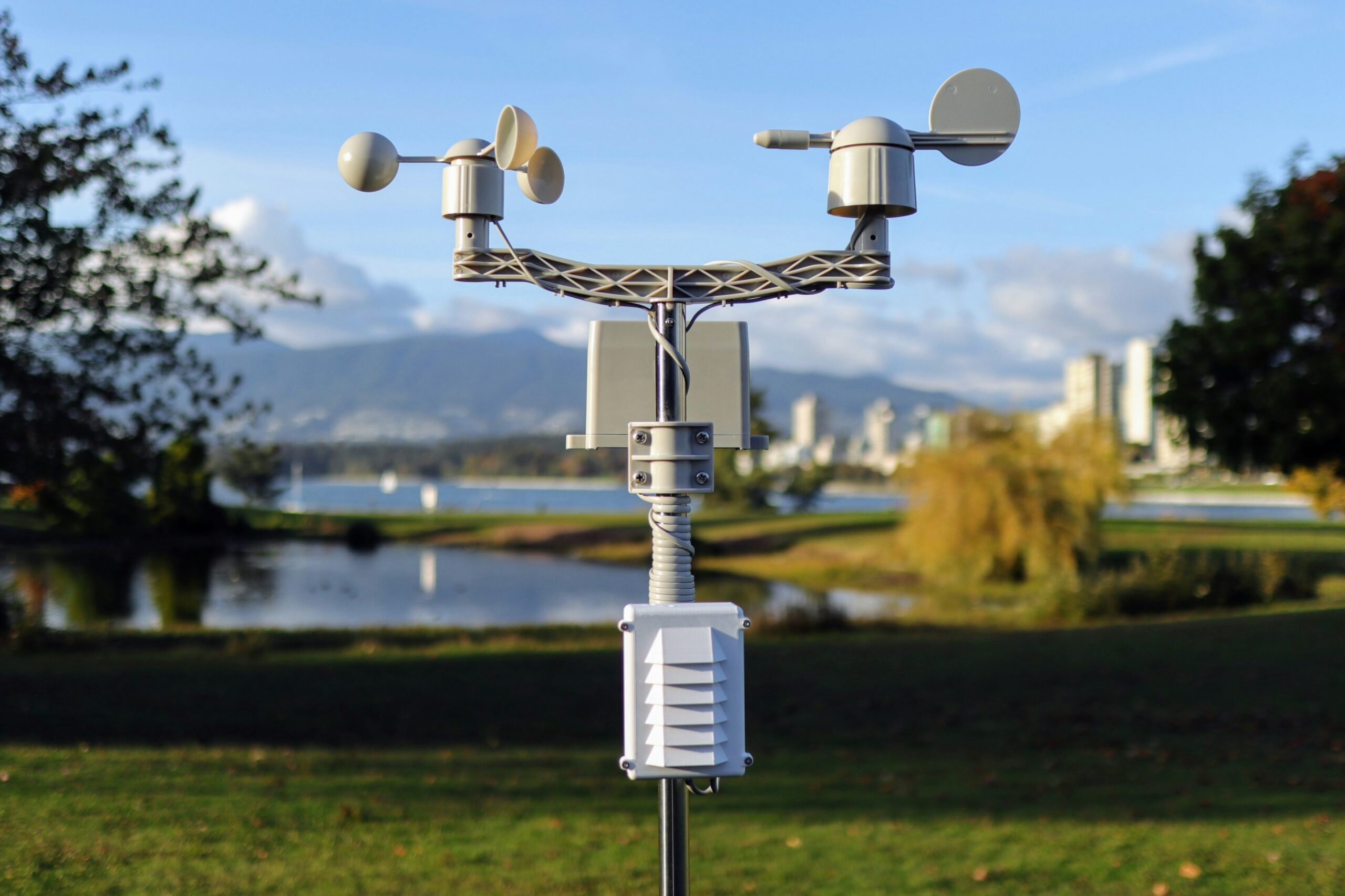 Weather monitoring station with wind sensors mounted on a pole.
