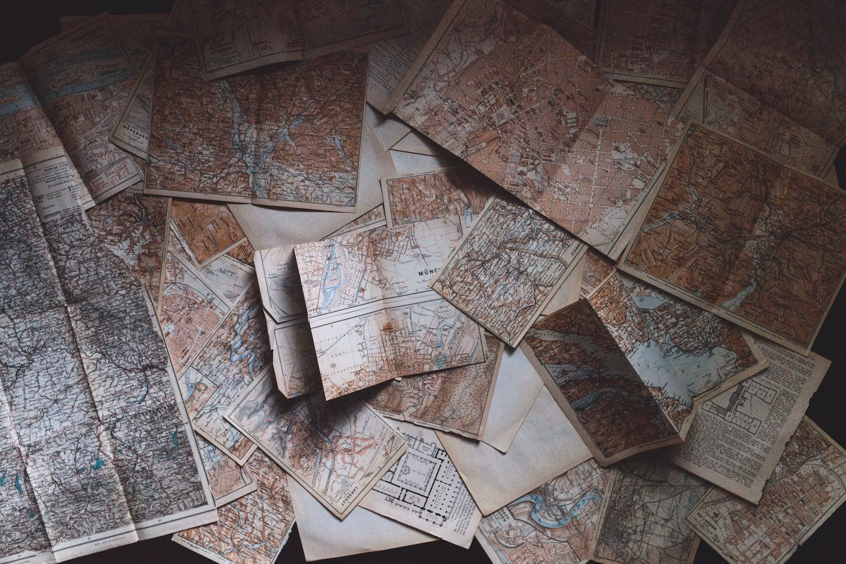 Assorted vintage maps laid out together.